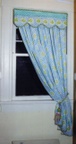 Shaped valance over panel, custom window treatments and drapery